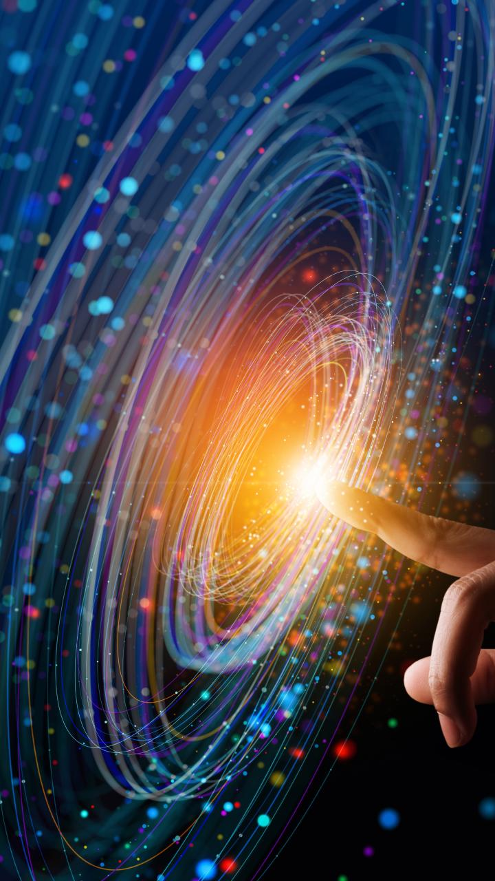 Blue swirling light on screen with finger at center