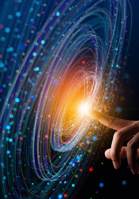 Blue swirling light on screen with finger at center