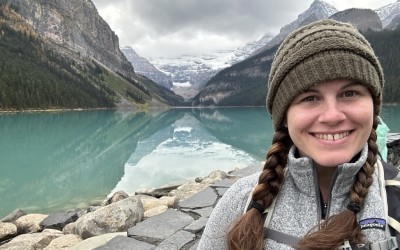 Melanie in front of mountains and blue lake