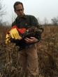 Kevin in the field collecting a juvenile bald eagle