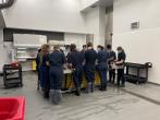 people standing at table with backs turned