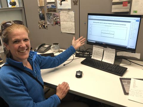 Brenda at her desk, showing math work on her computer screen