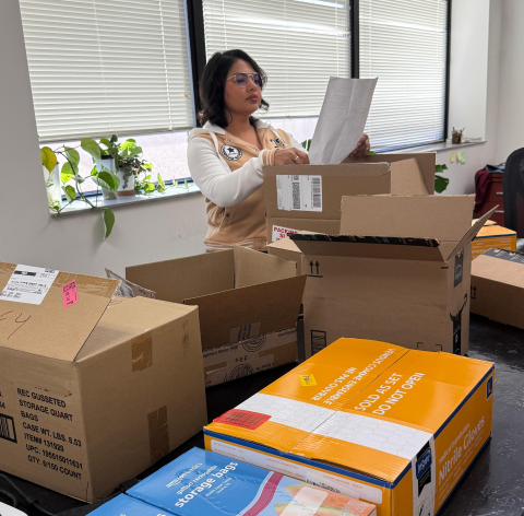 woman checkin paper on supply boxes