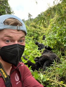 Adam with mask on near mountain gorillas