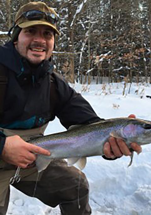 Gavin ice fishing and showing off his catch