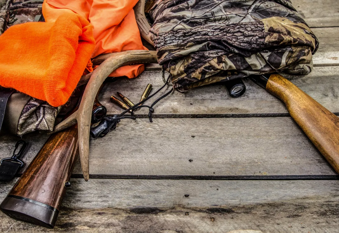 Hunting gear, camo and orange apparel and rifles