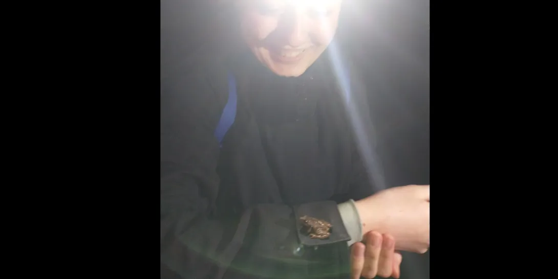 Allyssa with a frog at night