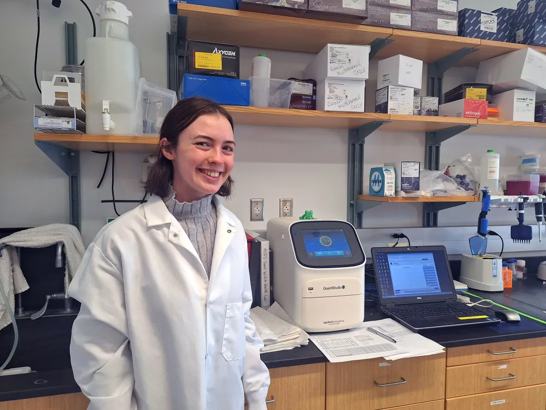 Woman standing in lab next to equipment