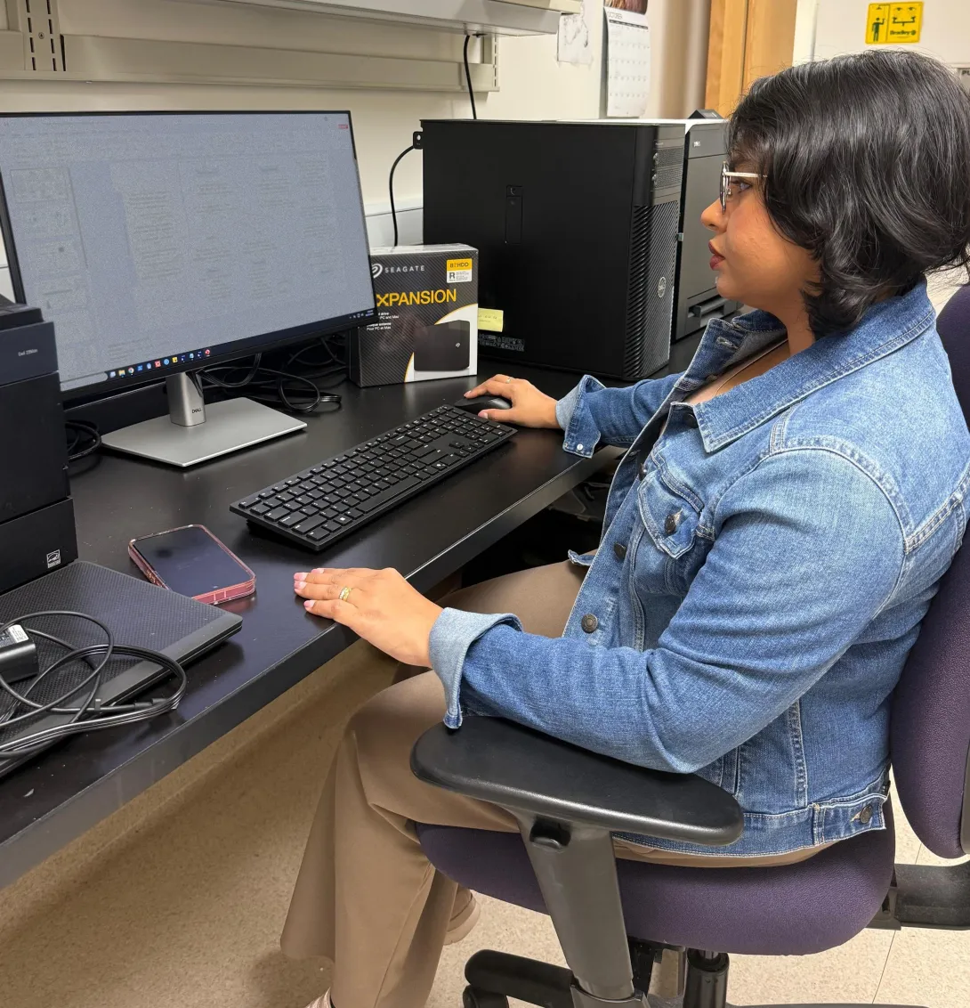 woman at her desk looking at computer monitor