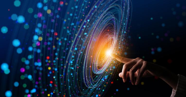 Blue swirling light on screen with finger at center