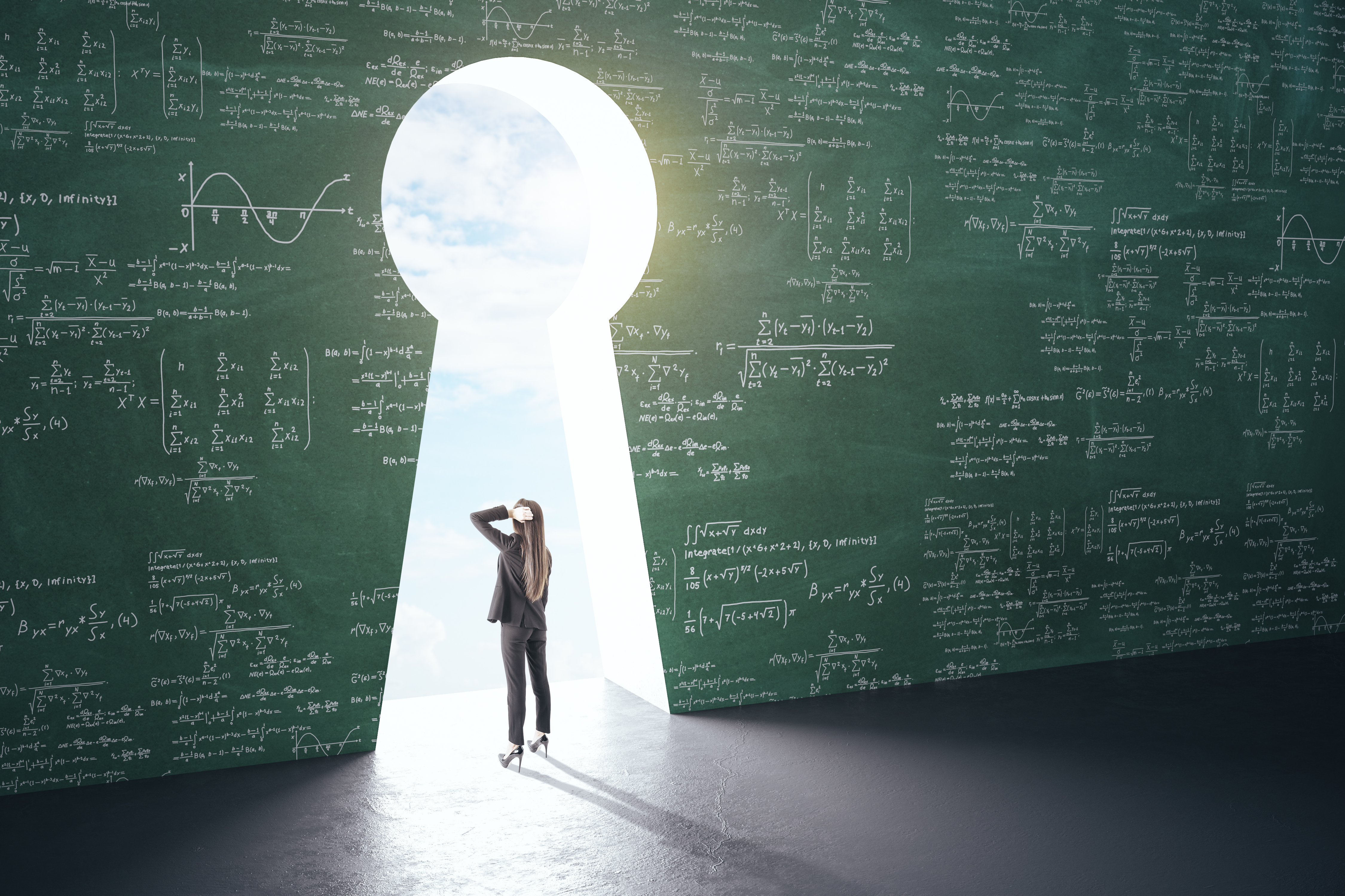 Woman standing in keyhole shaped opening of math equation covered wall