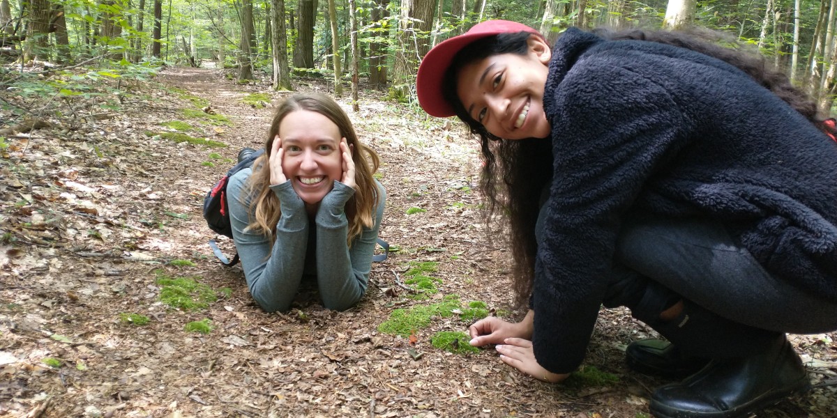 Paula and research specialist Melissa Fadden taking a break in the woods during fieldwork